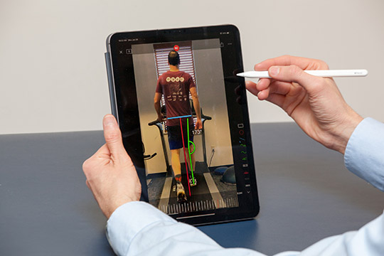 provider using ipad to perform biomechanical assessment of patient